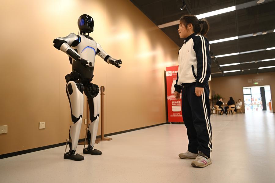 a child interacts with a robot
