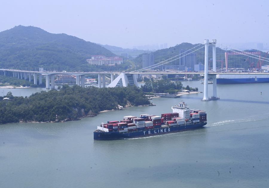 Container ship departing from Xiamen Port sails past the Haicang Bridge
 in Xiamen
