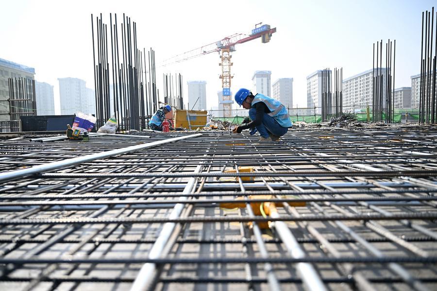 A staff member of the China Construction Second Engineering Bureau Ltd. works at the construction site of the Xiong'an campus of the University of Science and Technology Beijing in Xiong'an New Area, north China's Hebei Province.
